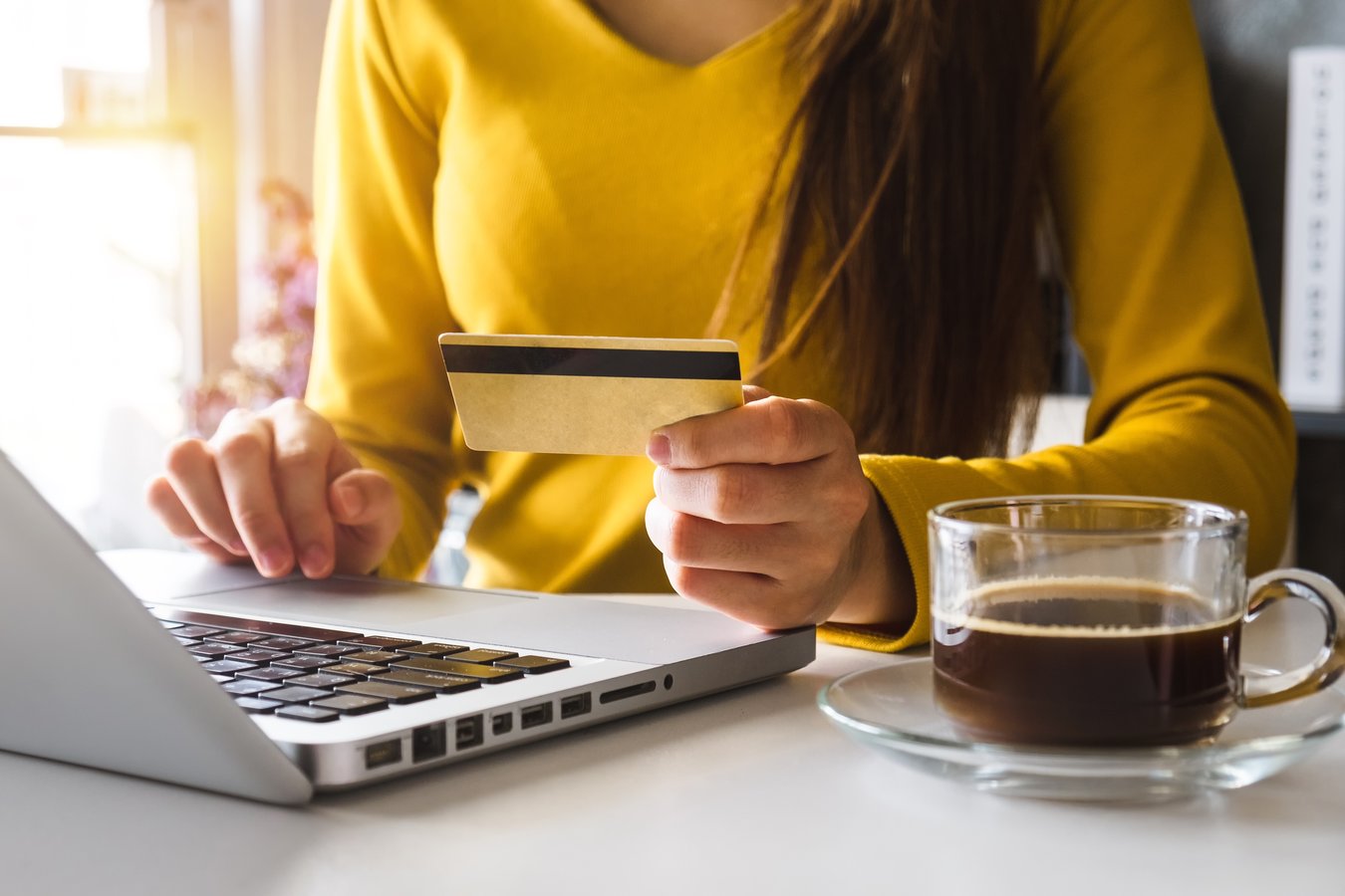 woman ordering online with a credit card and laptop