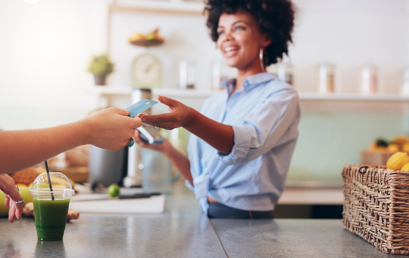 Clerk handing credit card to customer after transaction
